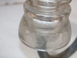 a small glass jar with a metal handle on a table