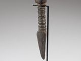 a wooden sculpture of a knife on a stand on a white background