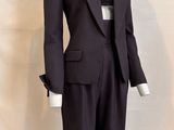 a mannequin wearing a suit and tie on a mannequin stand