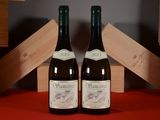 two bottles of wine sitting next to each other on a table