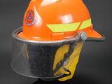 an orange hard hat with a clear visor on it