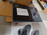 a laptop that is sitting on the floor with a sign on it