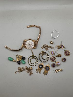 a lot of jewelry sitting on a white surface