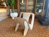 a wooden chair that is sitting on the carpet
