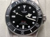 the black and white watch is on display on a white display stand