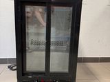 an image of a glass door refrigerator in a kitchen
