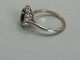 an image of a ring with a black stone in it
