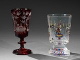 two glass goblets sitting next to each other on a table