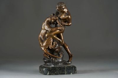 bronze statue of a man and a woman embracing on a marble base