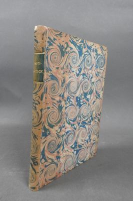 an old book sitting on top of a table next to a gray background