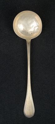 silver spoon on a black background with a silver spoon in the middle of the spoon