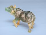 a figurine of an elephant on a blue background