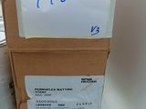 a cardboard box with a sign on it sitting on a shelf