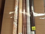plusieurs rouleaux de papier d'emballage posés sur une boîte en carton