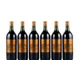 six bottles of red wine lined up in a row