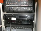 a rack of electronic equipment in a room with orange walls