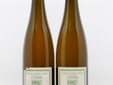 deux bouteilles de vin posées l'une à côté de l'autre sur une surface blanche