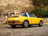 a yellow car parked on a cobblestone street