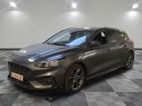 a grey ford focus is parked on a checkered floor