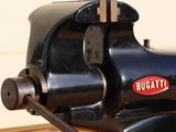 a picture of a bench vise on a wooden table
