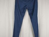 blue jeans on a hanger in front of a white curtain
