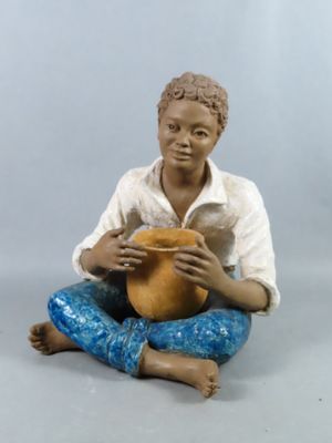 a figurine of a man sitting on the ground holding a pot