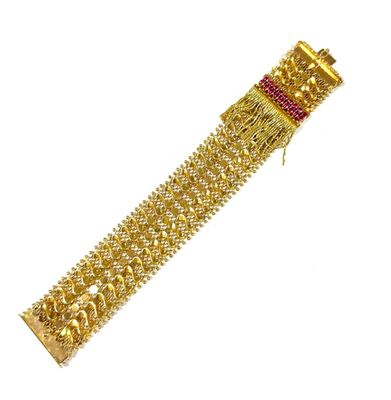 a close up of a gold bracelet on a white background