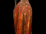 an old statue of a man with a long beard and a red robe