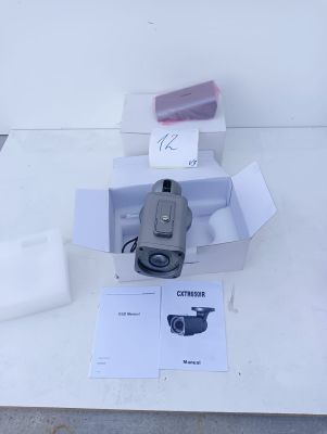a camera sitting on top of a table next to other items