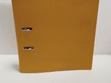 an image of a yellow binder sitting on top of a white table
