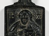 a black metal plaque with an image of a woman holding a baby