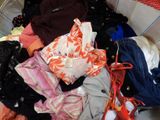 a basket full of clothes that is sitting on the floor