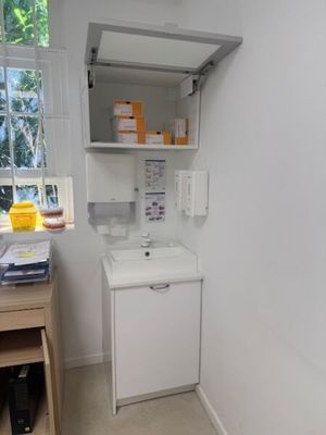 a small bathroom with a sink and a cabinet