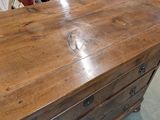 an image of a wooden dresser with drawers in a room