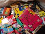 many children ' s books in a bag on the floor