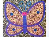 purple and yellow butterfly on a yellow background with blue dots