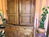 a large wooden cabinet in the corner of a room