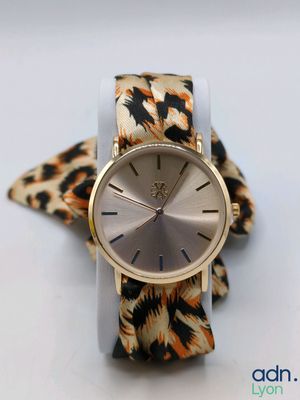 an image of a watch with a leopard print band on a white surface