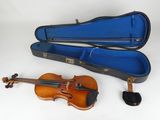 a violin and a violin case on a white surface