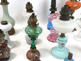 a lot of different colored glass lamps on a table