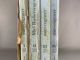 three books sitting on top of each other on a table