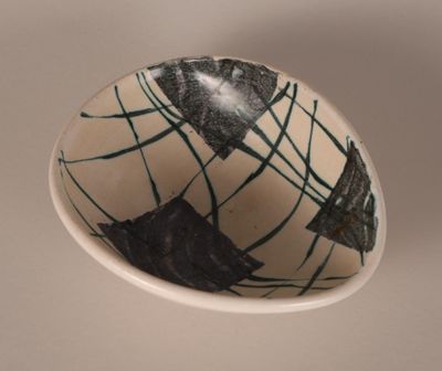 a white bowl with a black and white design on it