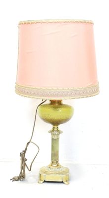 une lampe surmontée d'un abat-jour rose
