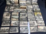 a lot of old black and white pictures on the table