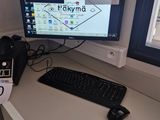 a desk with a keyboard and a monitor on it