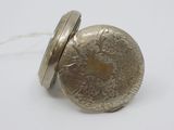 a silver pocket watch with a chain around it