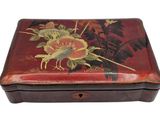 a small wooden box with a bird and flowers on it