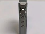 a close up of a remote control on a white surface