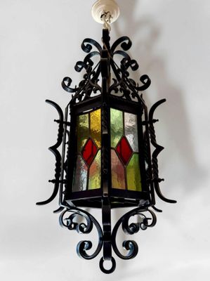 wrought iron hanging light fixture with stained glass panels