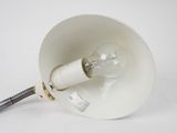 a white lamp that is on a white table